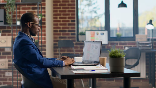 Young man using laptop on table