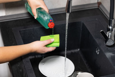 Cropped hand of person washing hands