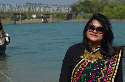 Portrait of woman wearing sari standing against sea