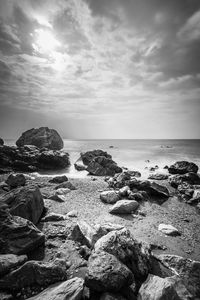 Rocks on beach against sky