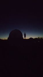 Low angle view of silhouette people against sky at night