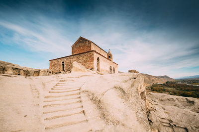 Low angle view of castle against cloudy sky