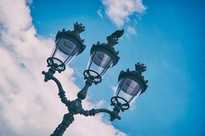 Low angle view of street light against cloudy sky