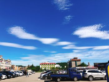 Cars on road against blue sky