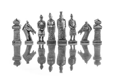 Low angle view of chess board against white background