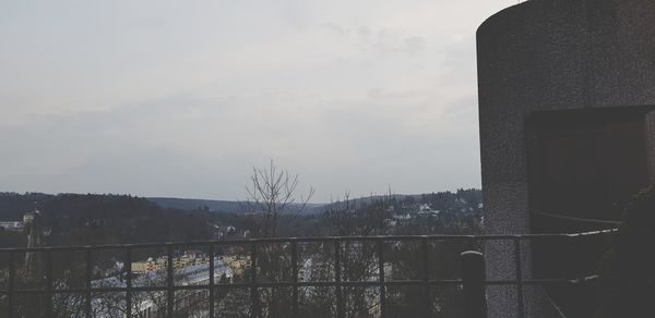 Buildings against sky seen through glass window