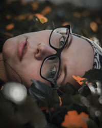 Close-up portrait of young woman wearing eyeglasses