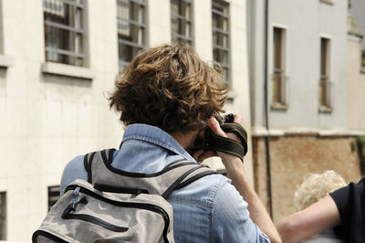 Rear view of photographer photographing