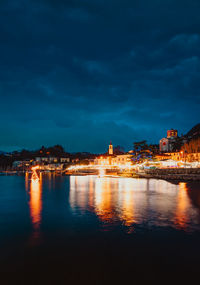 View of laveno with christmas lighting on lake maggiore at night
