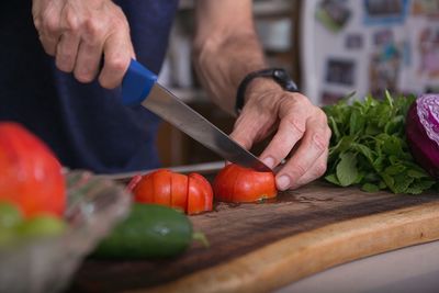 Midsection of man preparing food in kitchen