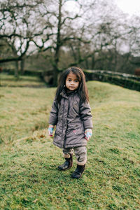 Portrait of girl standing on field