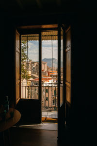 The view on the city with old buildings through the window and balcony, home, tranquil scene. 