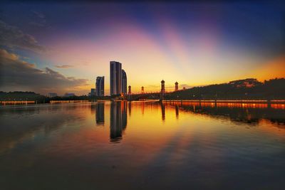 Scenic view of lake by sea against romantic sky at sunset