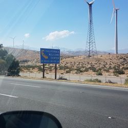 Road sign against sky
