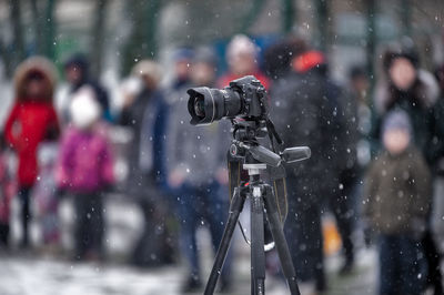 People photographing on snow covered camera