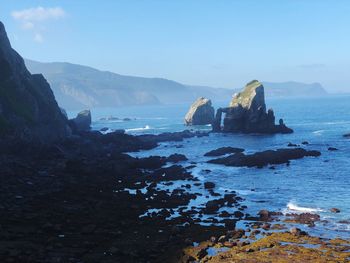 Scenic view of sea and rock formation against sky