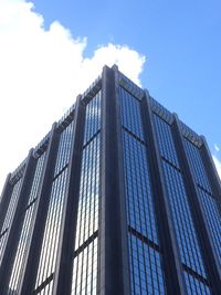 Low angle view of modern building against blue sky