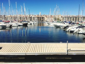 Sailboats moored at harbor