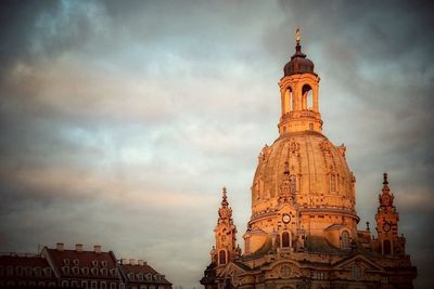 Low angle view of church against cloudy sky