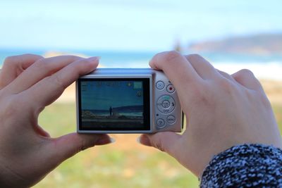 Cropped image of person holding mobile phone