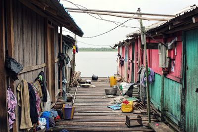 Clothes drying on clothesline by sea against sky