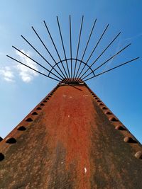 Low angle view of roof of building against blue sky