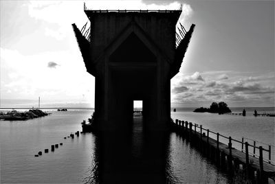 View of pier on sea against cloudy sky
