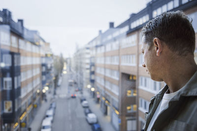 Man looking through window at street