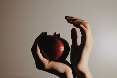 Cropped hand holding apple