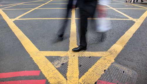 Low section of man walking in city