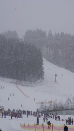 High angle view of people on snow covered landscape