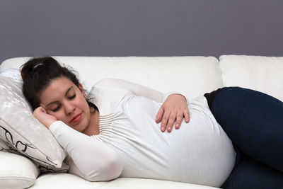 Young woman sleeping on sofa at home