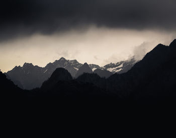 Scenic view of mountains against cloudy sky