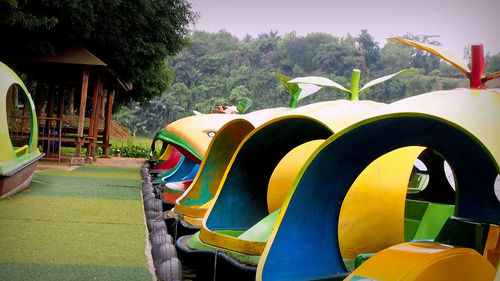 Empty playground against trees in park