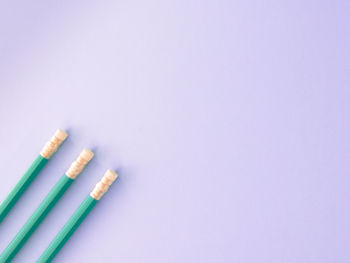 Close-up of colored pencils over white background