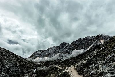 Low angle view of mountains against dramatic sky