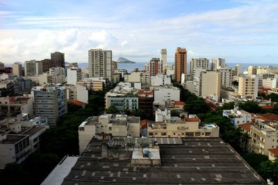 View of cityscape against cloudy sky