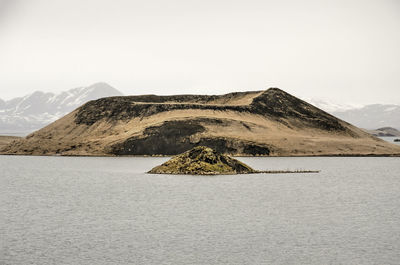 View across lake myvatn in iceland towards one of the well-known pseudocraters and a little island