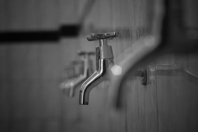 Close-up of faucets in bathroom