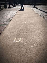 Person walking on footpath in city