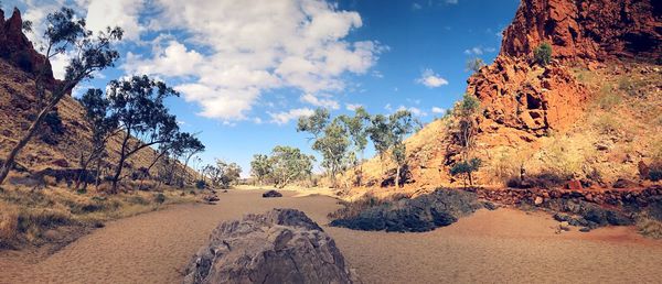 Panoramic view of rocks and trees against sky