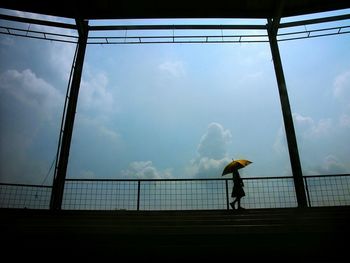 Silhouette of man against cloudy sky