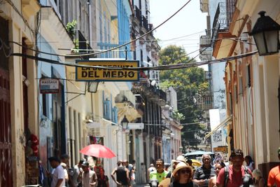 People on street amidst buildings in city