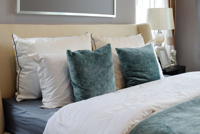 Pillows arranged on bed at home