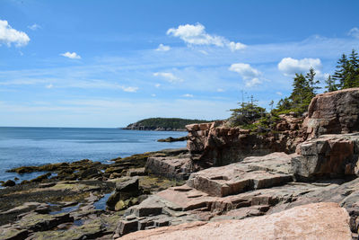 Rocks on beach against sky