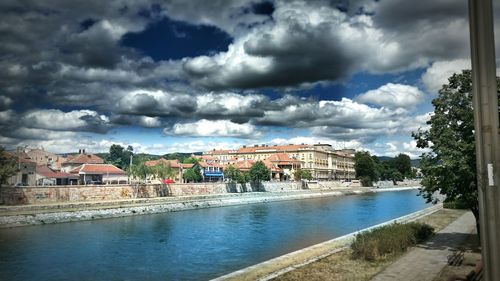 View of town against cloudy sky