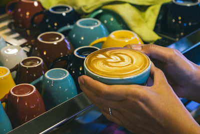 Close-up of cropped hand coffee cup