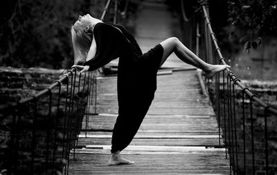 Woman standing on footbridge