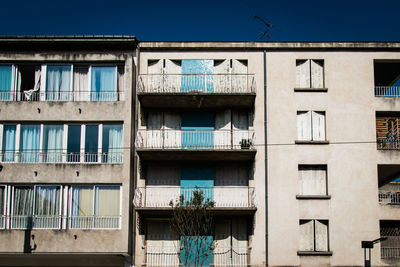 Low angle view of residential building against blue sky