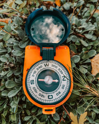 The compass lies on the grass. travel and discovery concept. vertical photo.